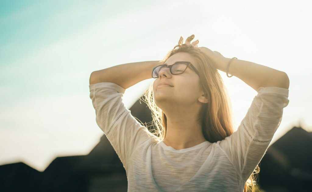 woman smiling arms up