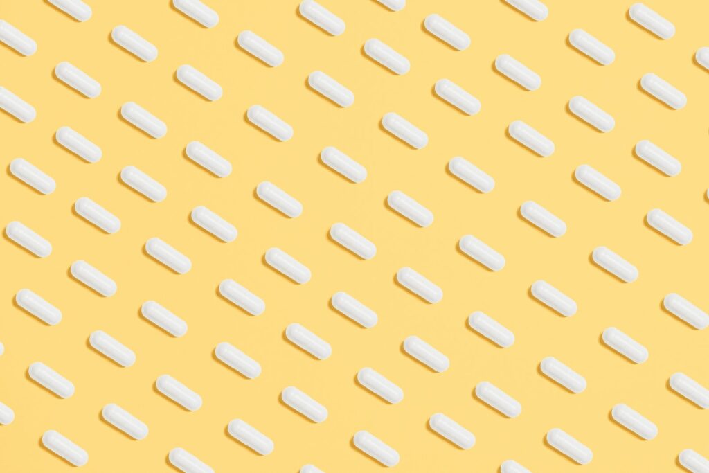 White Capsules on Yellow Background