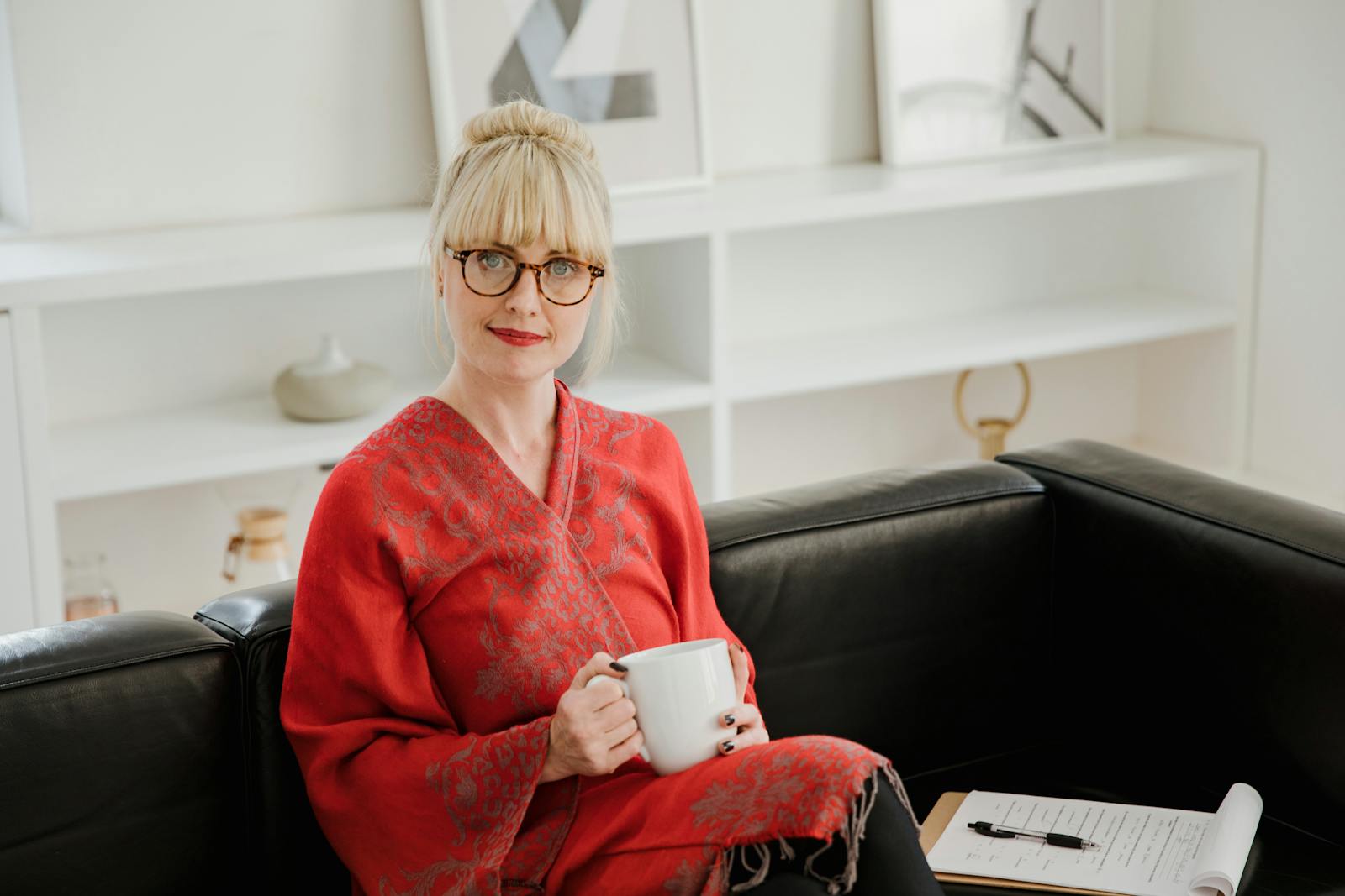 Psychologist Sitting on a Sofa with a Cup and Notes