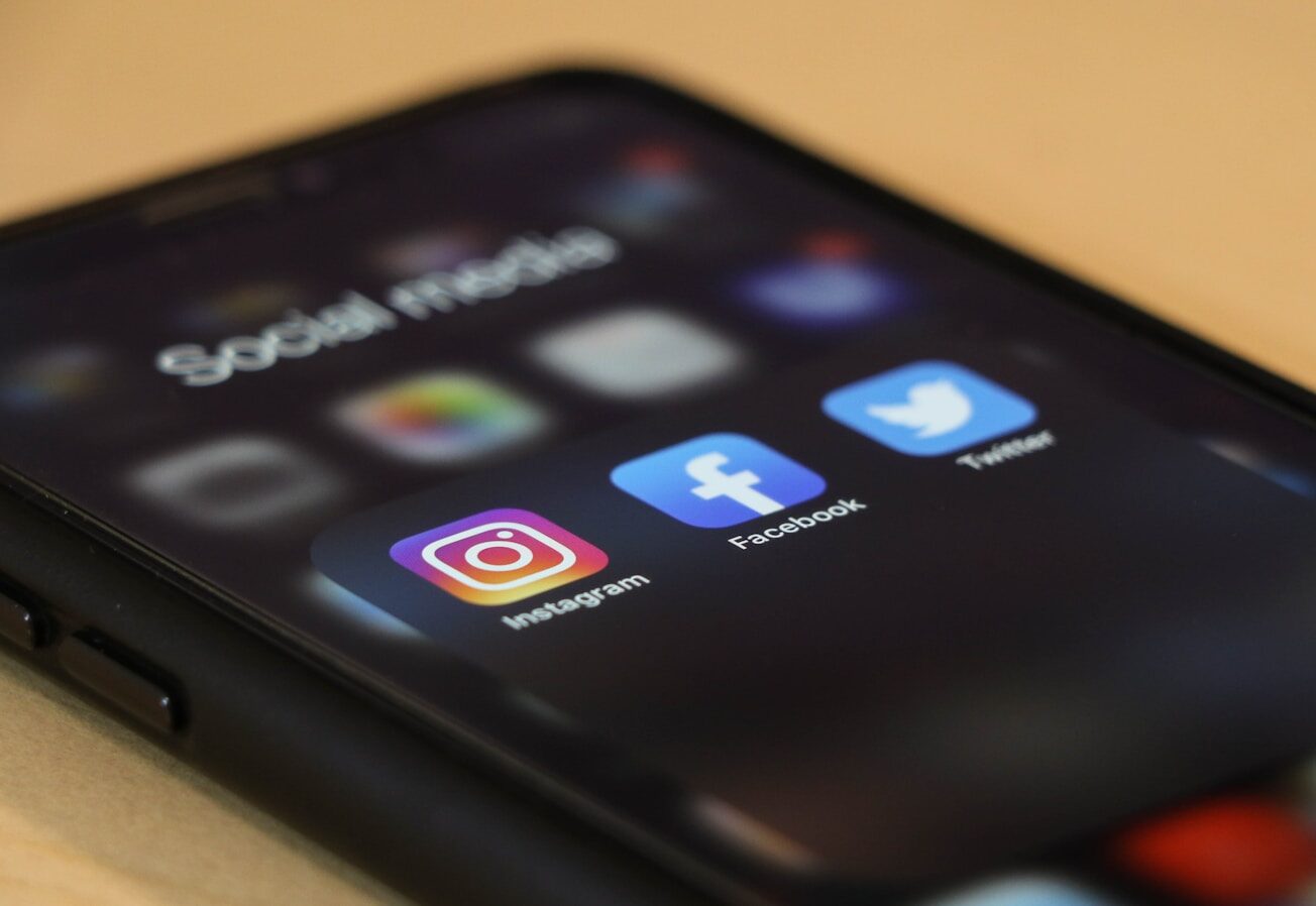 black iphone 4 with social media apps