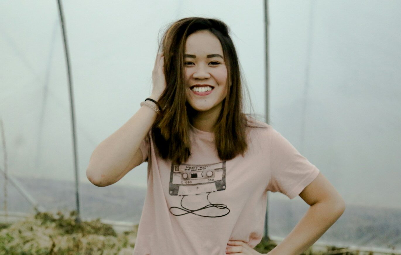 smiling woman holding her head